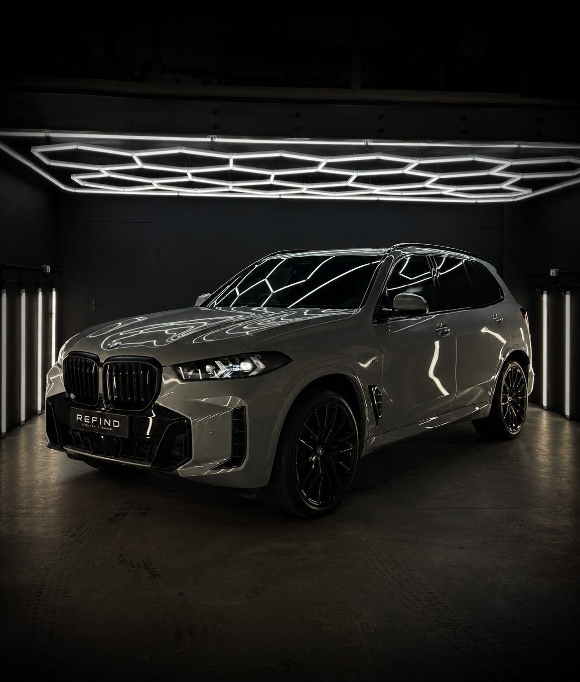 Black BMW X5 prepared in a dark detailing studio