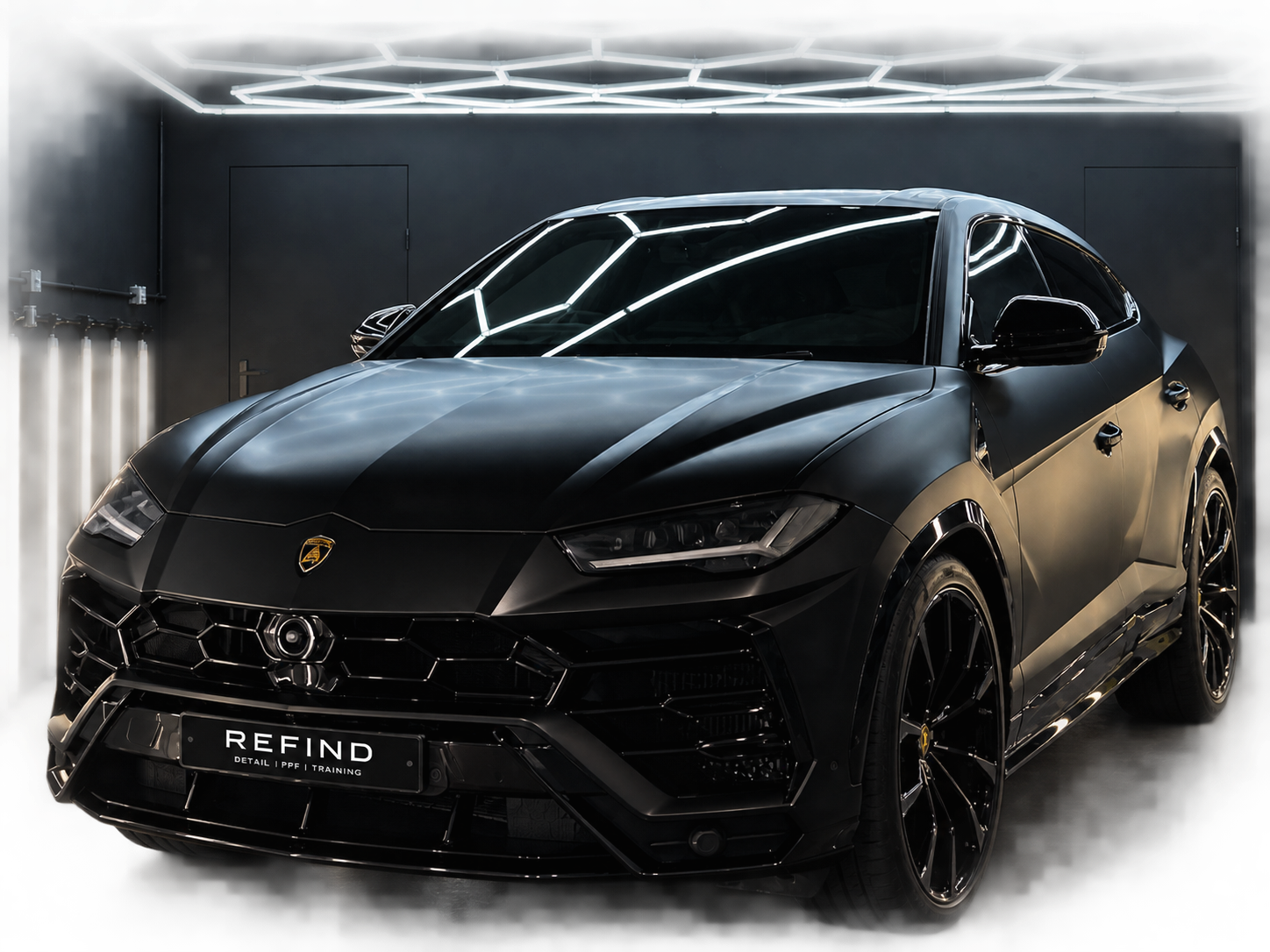 Satin black Lamborghini Urus detailed under studio lighting
